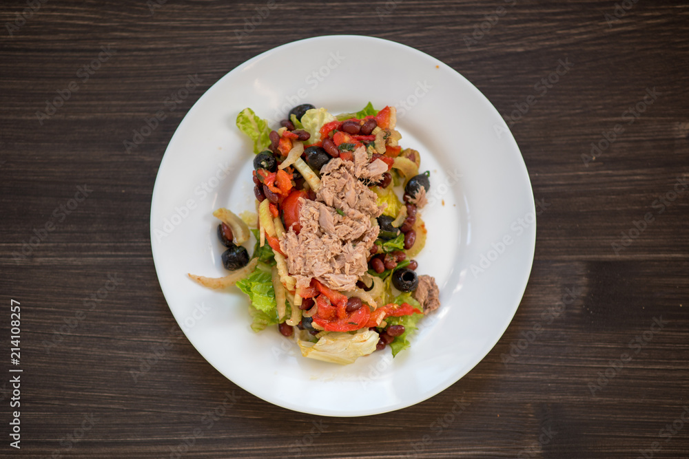 photo of a real meal on a dark background on a white plate. photo of a real meal on a dark background on a white plate.
