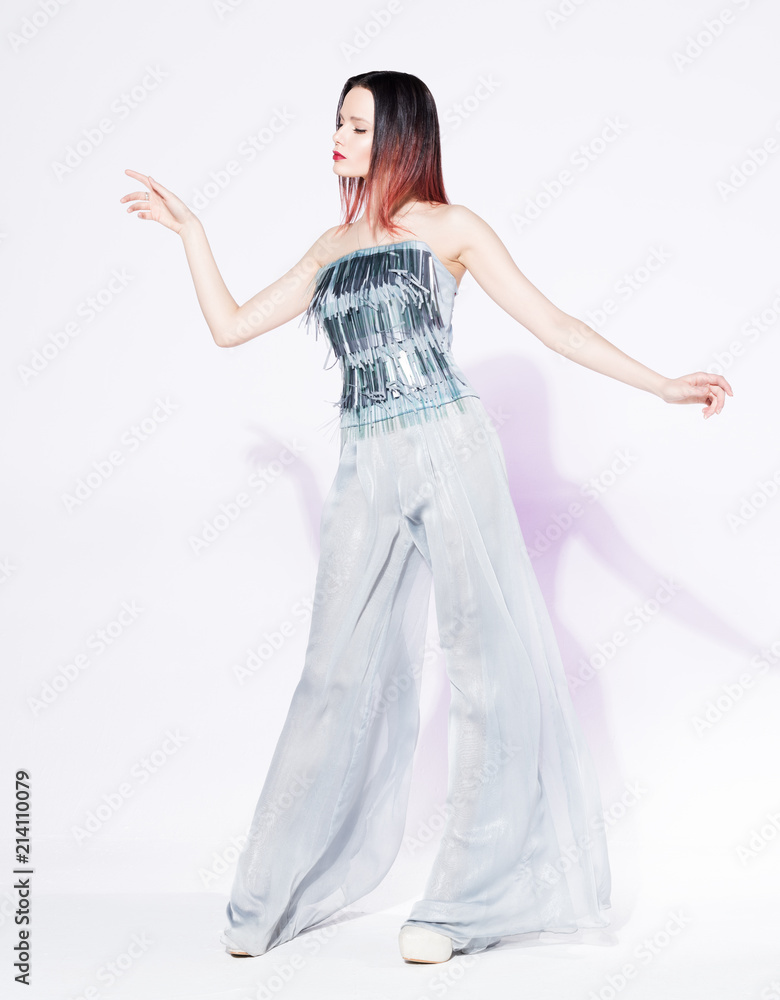Young beautiful woman posing in stylish clothes. Fashion silver blouse and wide-leg trousers Young beautiful woman posing in stylish clothes. Fashion silver blouse and wide-leg trousers