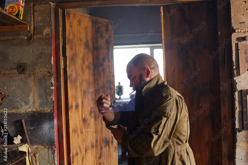 Man's den workshop inside man rolling up sleeves before work Man's den workshop inside man rolling up sleeves before work