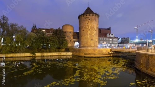 Motlawa river flow near Brama Stagiewna (Milk cans gate) at night in Gdansk, Poland
 photo