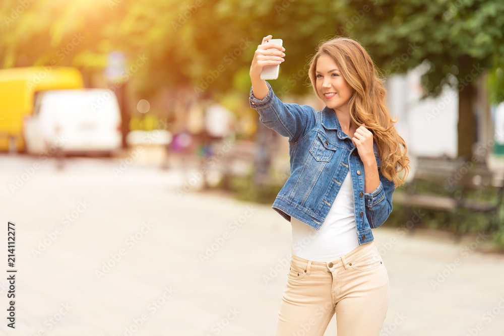 Beautiful woman taking a selfie with her phone