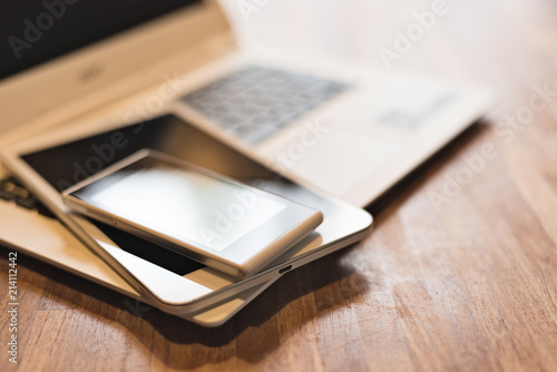 phone and tablet on a laptop