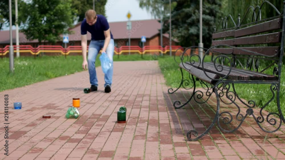A man walks through the city and collects garbage in a package, garbage collection, fighter for cleanliness A man walks through the city and collects garbage in a package, garbage collection, fighter for cleanliness
