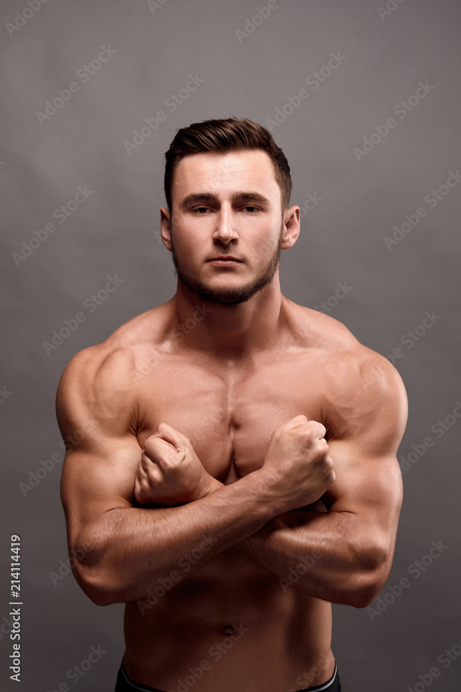 Fototapeta premium Athletic Man Fitness Model Torso showing big muscles.