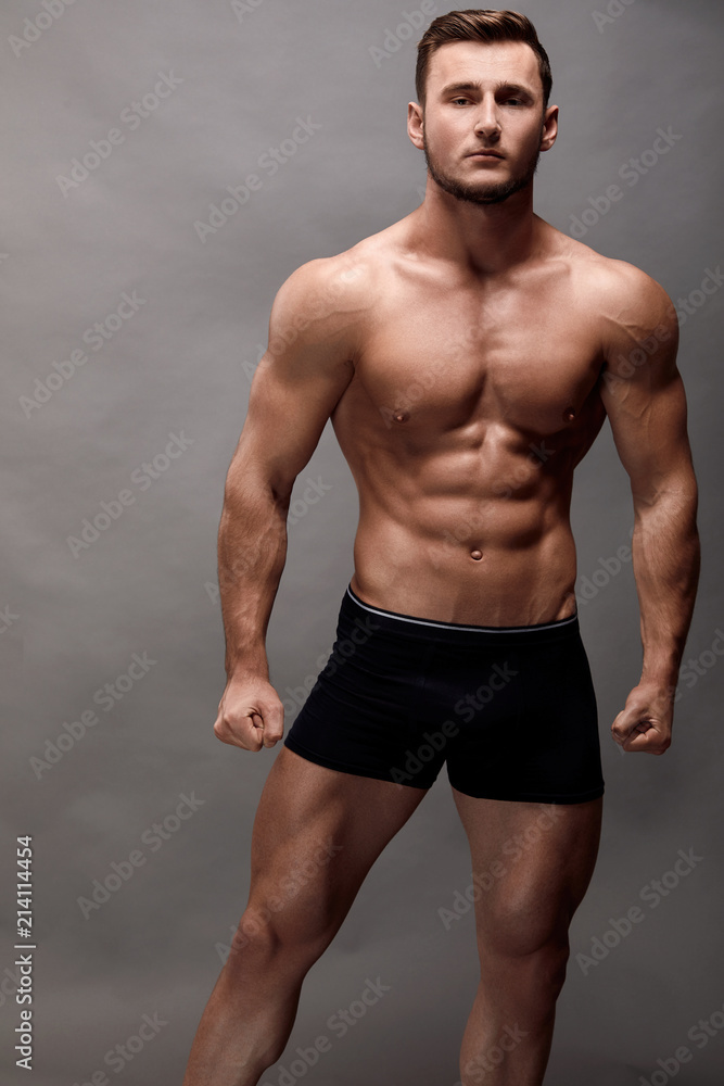 Fototapeta premium Athletic Man Fitness Model Torso showing big muscles.
