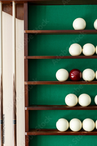 White billiard balls and cue ball for Russian billiards on the shelf photo