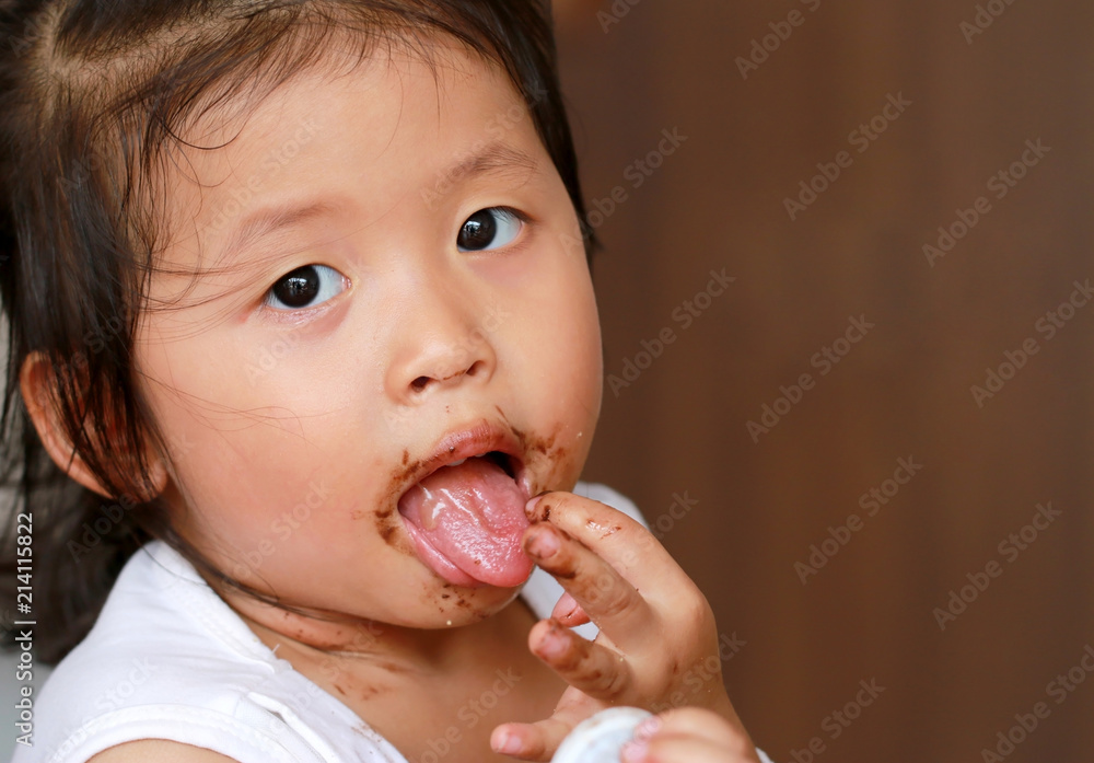 little girl with chocolate all over her face little girl with chocolate all over her face