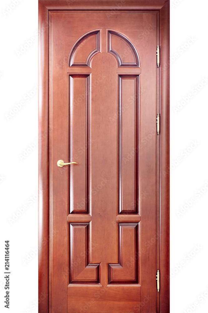 Naklejka premium Wooden interior carved door in a door frame made of cherry tree with a brass handle with geometric ornaments isolated on white