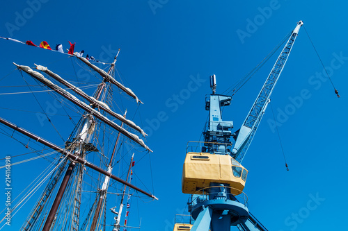 Segelschiff und Hafenkran im Stadthafen von Rostock photo