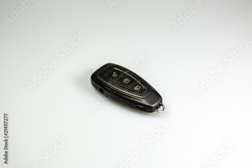 A black car keyless entry and starting device laying on a table