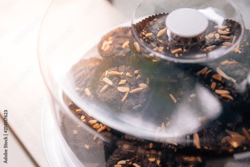 Fototapeta premium Pile of Brownies topping with almond in glass lid.