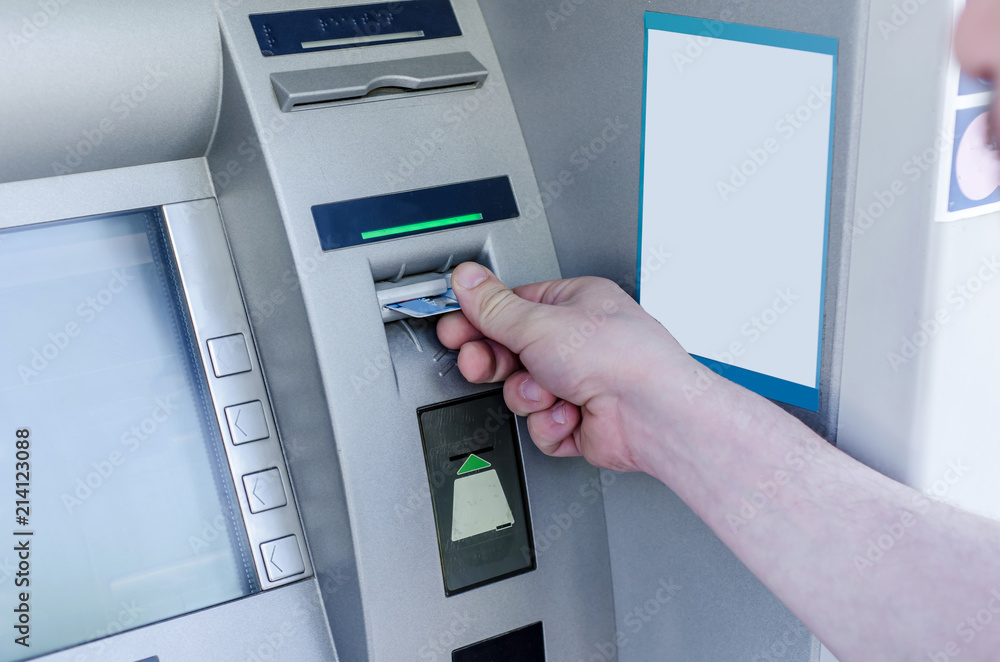 Man hand puts card, press button gray ATM Man hand puts card, press button gray ATM