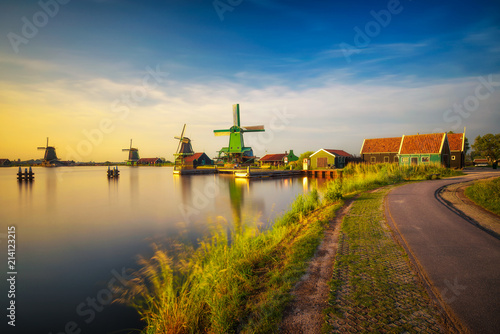 Sunset above farm houses and windmills of Zaanse Schans in the Netherlands photo