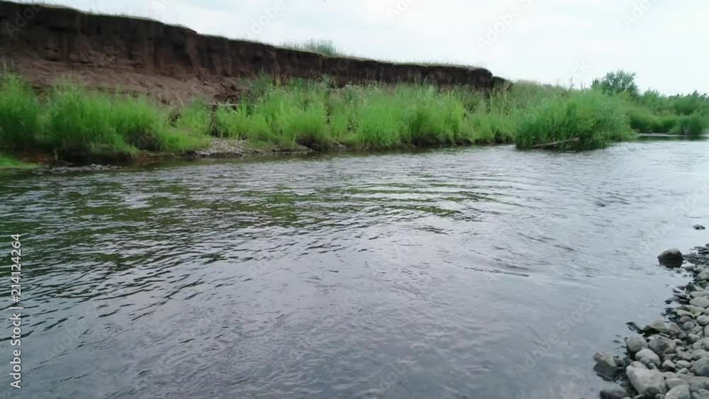Clean river in nature. Movement of water in a small country river. Clean river in nature. Movement of water in a small country river.