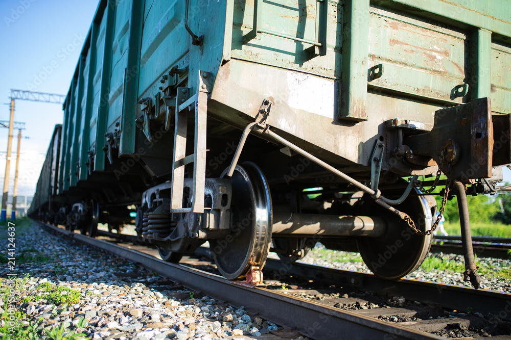 Naklejka premium railroad cars loaded with coal, the train transports coal. loading of wagons with coal. night views.