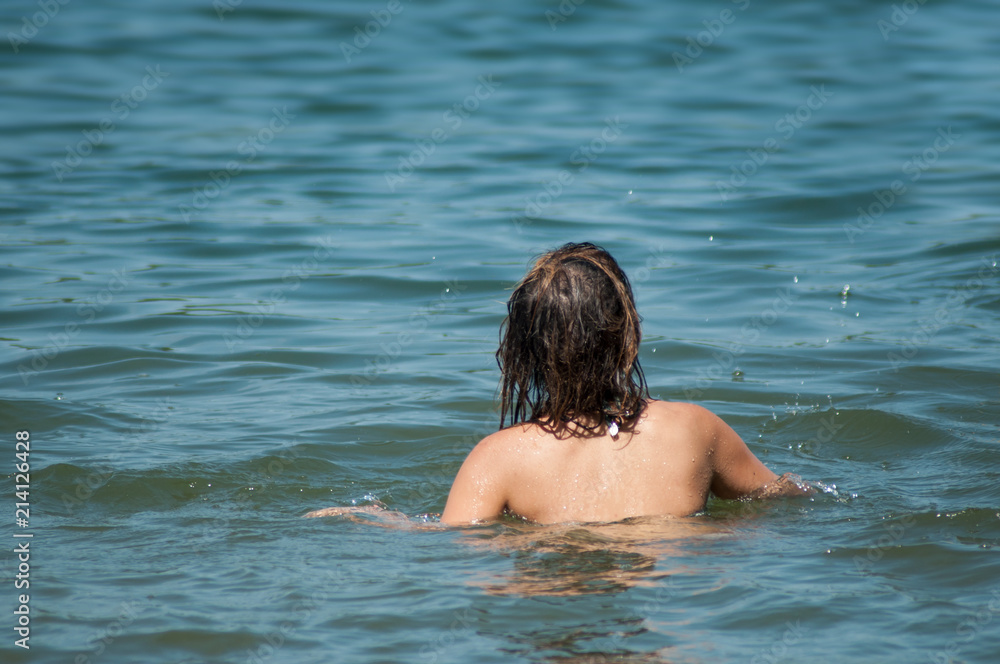 portrait of woman swimming in the lake on back view portrait of woman swimming in the lake on back view