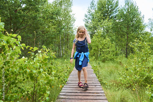  Child little blond girl exploring nature at Soumarske moor (peat-bog), National Park Sumava, Bohemian forest, Czech Republic
 photo