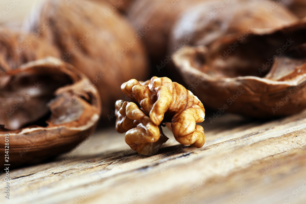 Walnut kernels and whole walnuts on rustic old table. Walnut kernels and whole walnuts on rustic old table.