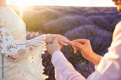 Fototapeta Naklejka Na Ścianę i Meble -  Marriage proposal in a field of lavender in the evening at sunset.