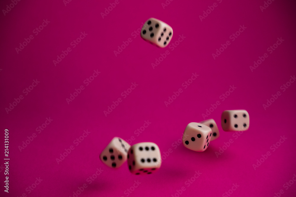 dice in fall on magenta background dice in fall on magenta background