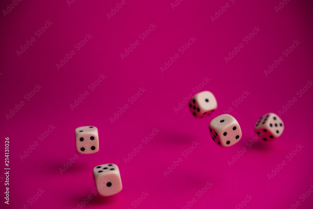 dice in fall on magenta background dice in fall on magenta background