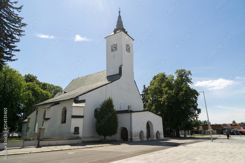 Building, Church and town during sunny day with clouds on sky. Slovakia