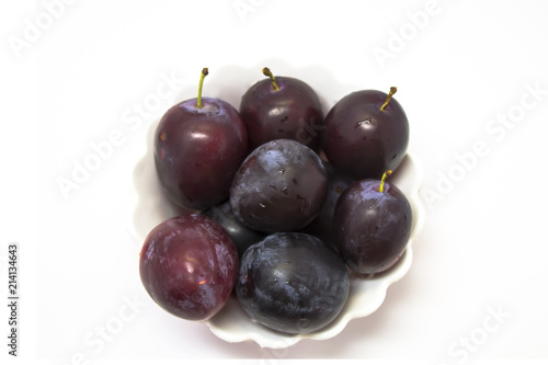Plums in a vase on a white background isolated.