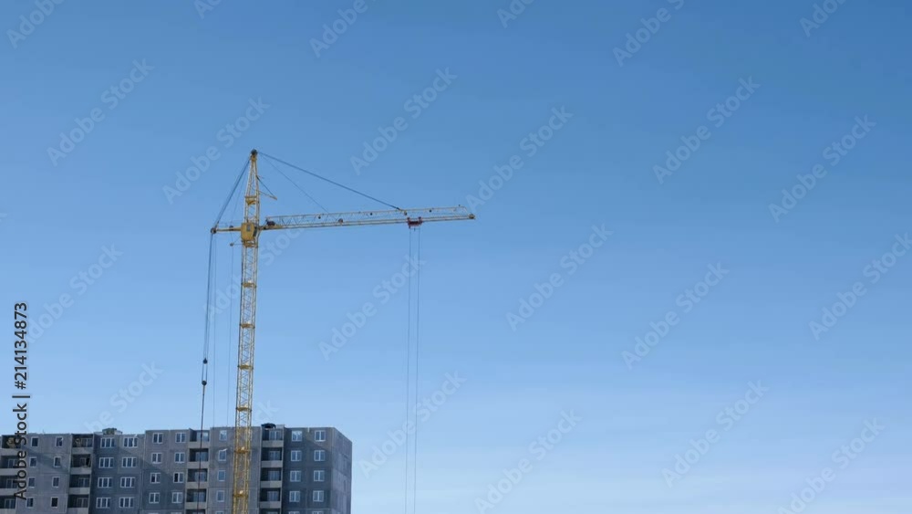 Construction of a multi-storey building. Crane turns to the side. Construction of a multi-storey building. Crane turns to the side.