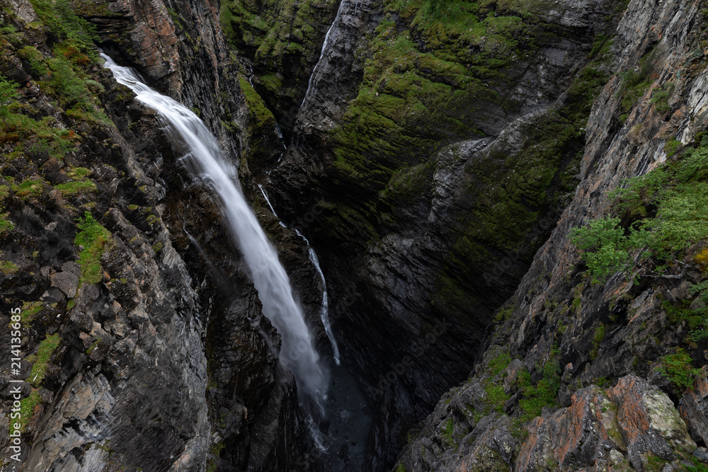 Magnificent waterfall falls onto the bottom of the Gorsa canyon in Lyngenfjord, Norway.