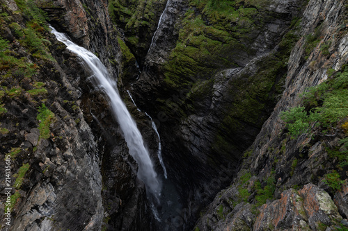 Magnificent waterfall falls onto the bottom of the Gorsa canyon in Lyngenfjord, Norway.