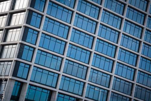 Abstract view of modern blue glass business center on a clear sky background