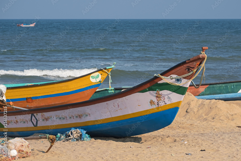 Naklejka premium Part of the local fishing fleet stranded on the beach at Mamallapuram in Tamil Nadu, India. The main catches taken in the Bay of Bengal inshore fishery are pomfrets and prawns