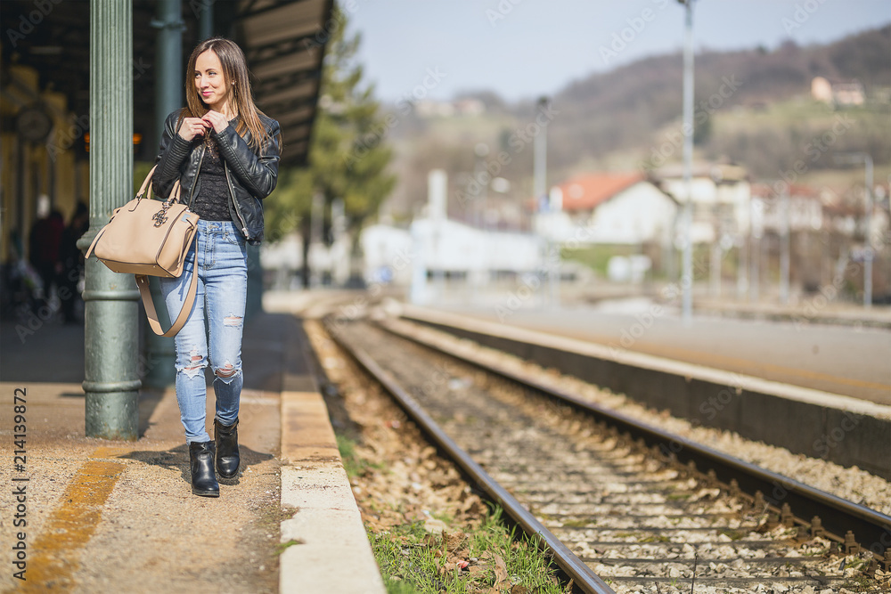 Traveler girl walking and waits train