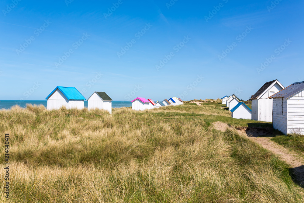 Colorful wooden beach cabins in the dunes, Gouville-sur-Mer, Normandy, France