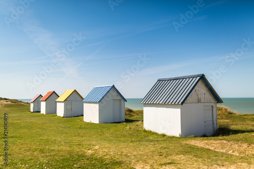 Colorful wooden beach cabins in the dunes, Gouville-sur-Mer, Normandy, France