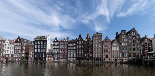 Amsterdam, Netherlands, May 2018: Classic Amsterdam buildings on the water front