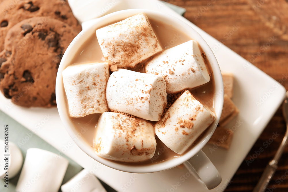 Cup of delicious cocoa drink with marshmallows and cookies on plate, top view Cup of delicious cocoa drink with marshmallows and cookies on plate, top view