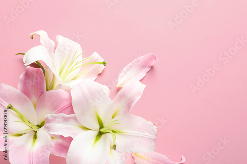 Flat lay composition with beautiful blooming lily flowers on color background © New Africa