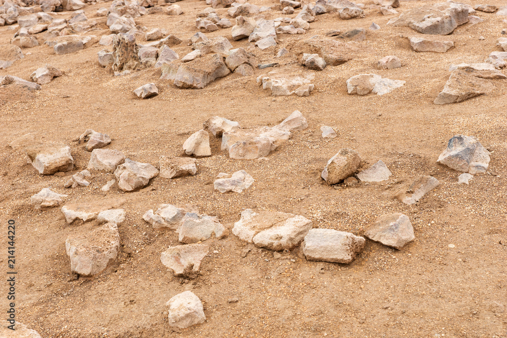 Pointed stones on sand. Sand and stone background Pointed stones on sand. Sand and stone background