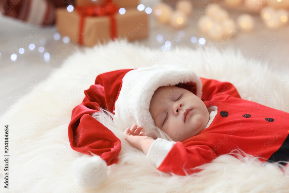 Cute baby in Christmas costume sleeping on fur rug Cute baby in Christmas costume sleeping on fur rug