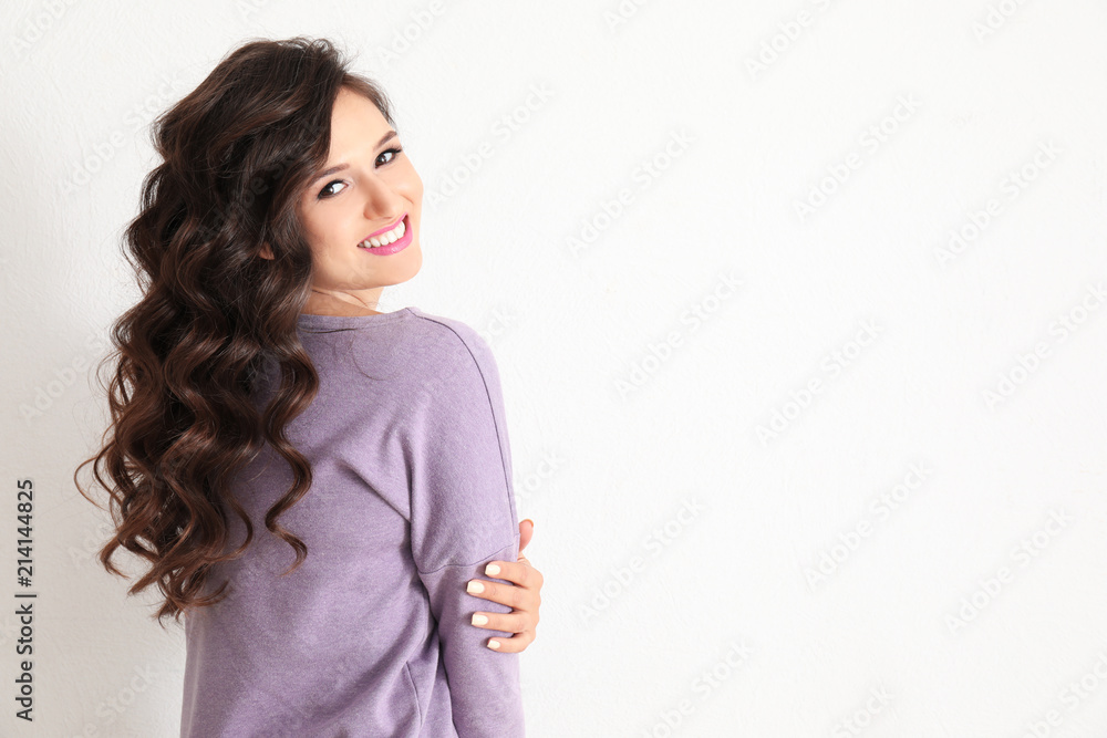 Portrait of beautiful young woman on light background Portrait of beautiful young woman on light background