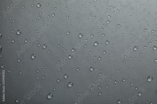 Many clean water drops on grey background