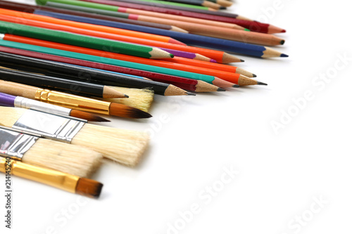 Brushes and pencils of professional artist on table, closeup