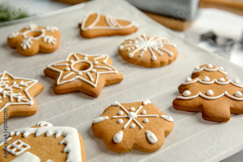Tasty decorated Christmas cookies on baking parchment