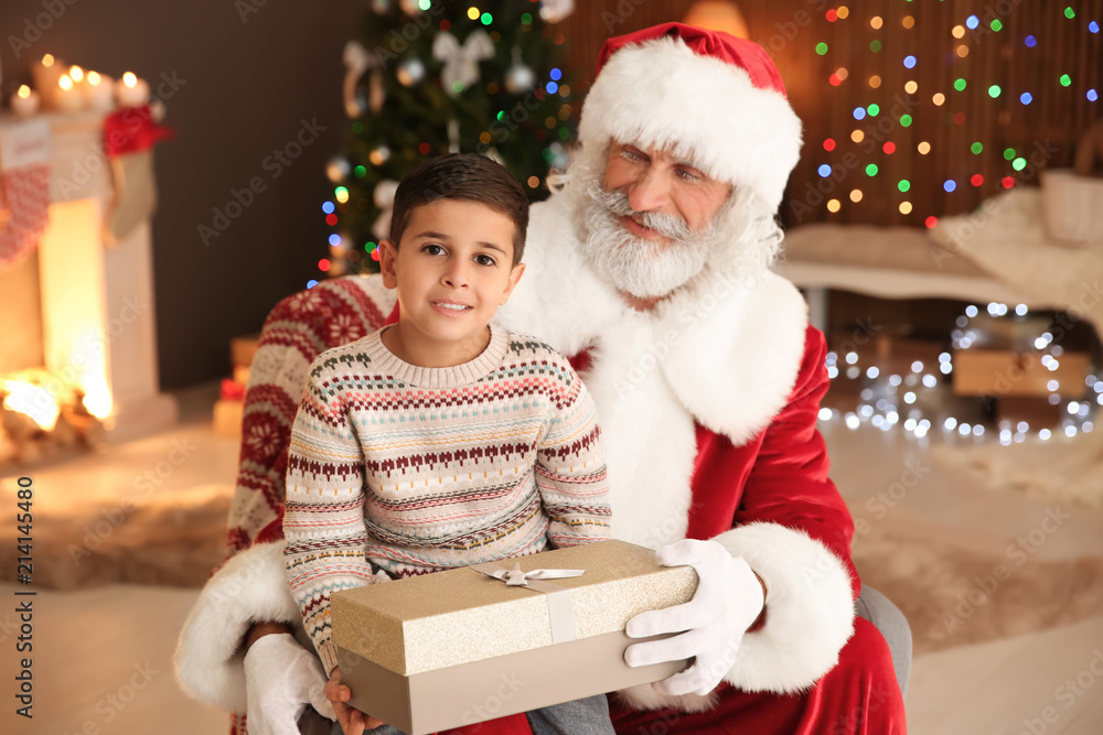 Little child with Santa Claus and Christmas gift at home Little child with Santa Claus and Christmas gift at home
