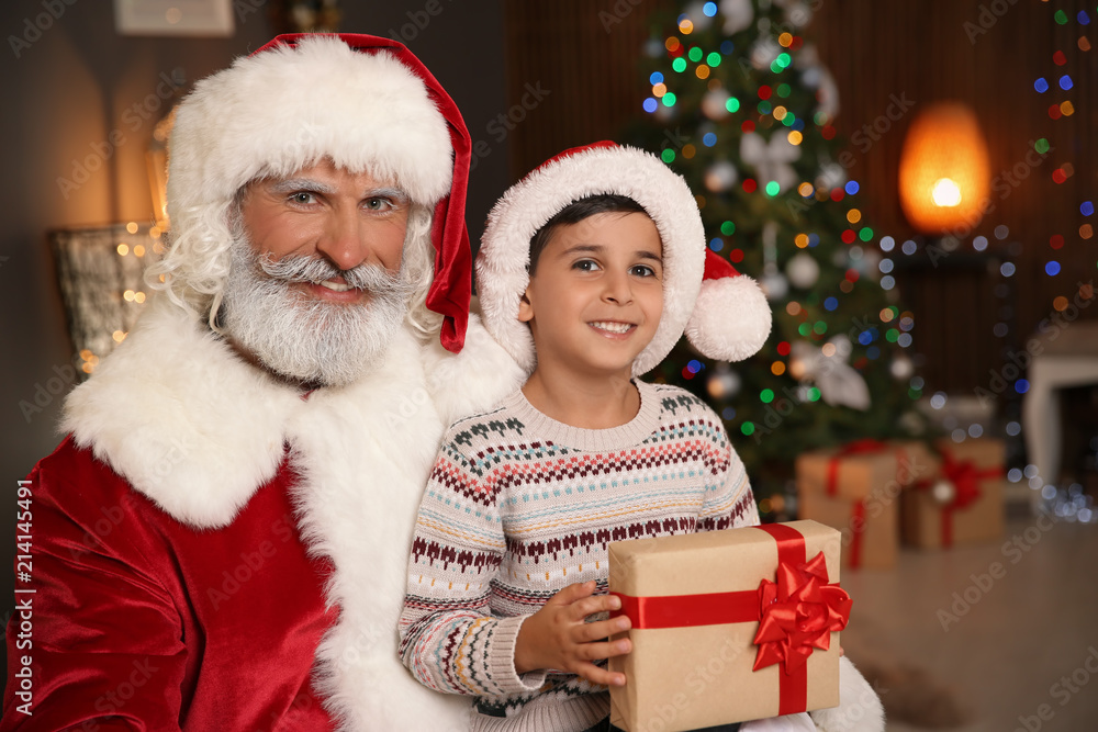 Little child with Santa Claus and Christmas gift at home Little child with Santa Claus and Christmas gift at home