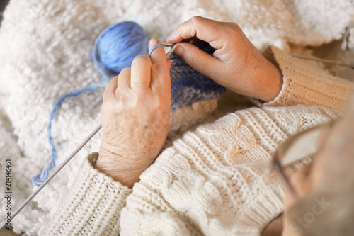 Senior woman knitting warm ...