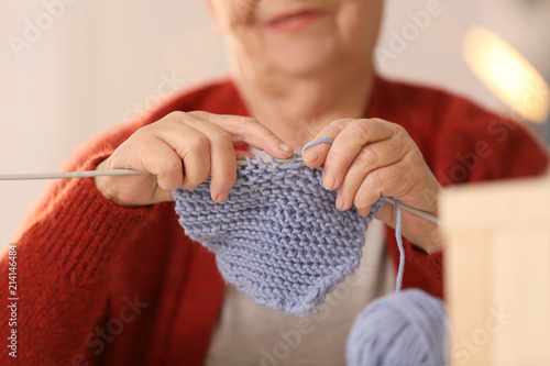 Senior woman knitting warm ...