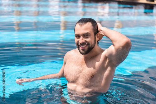 smiling bearded man standing in swimming pool © LIGHTFIELD STUDIOS