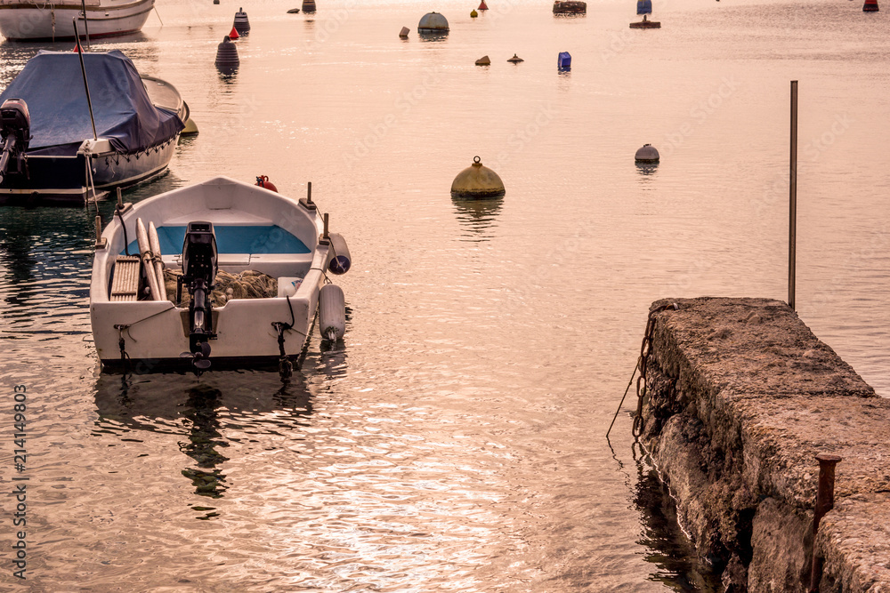Landscape view of a small boat standing in a port buoy around. Summer in Zurkovo, Rijeka,Croatia.